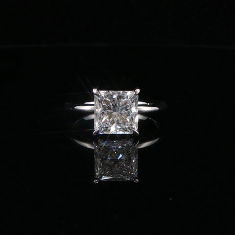 Diamond ring with a radiant-cut gemstone on a black background
