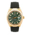 Rolex Datejust wristwatch with a gold-tone case, green dial, and black rubber strap, shown against a plain white background.