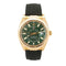 Rolex Datejust wristwatch with a gold-tone case, green dial, and black rubber strap, shown against a plain white background.